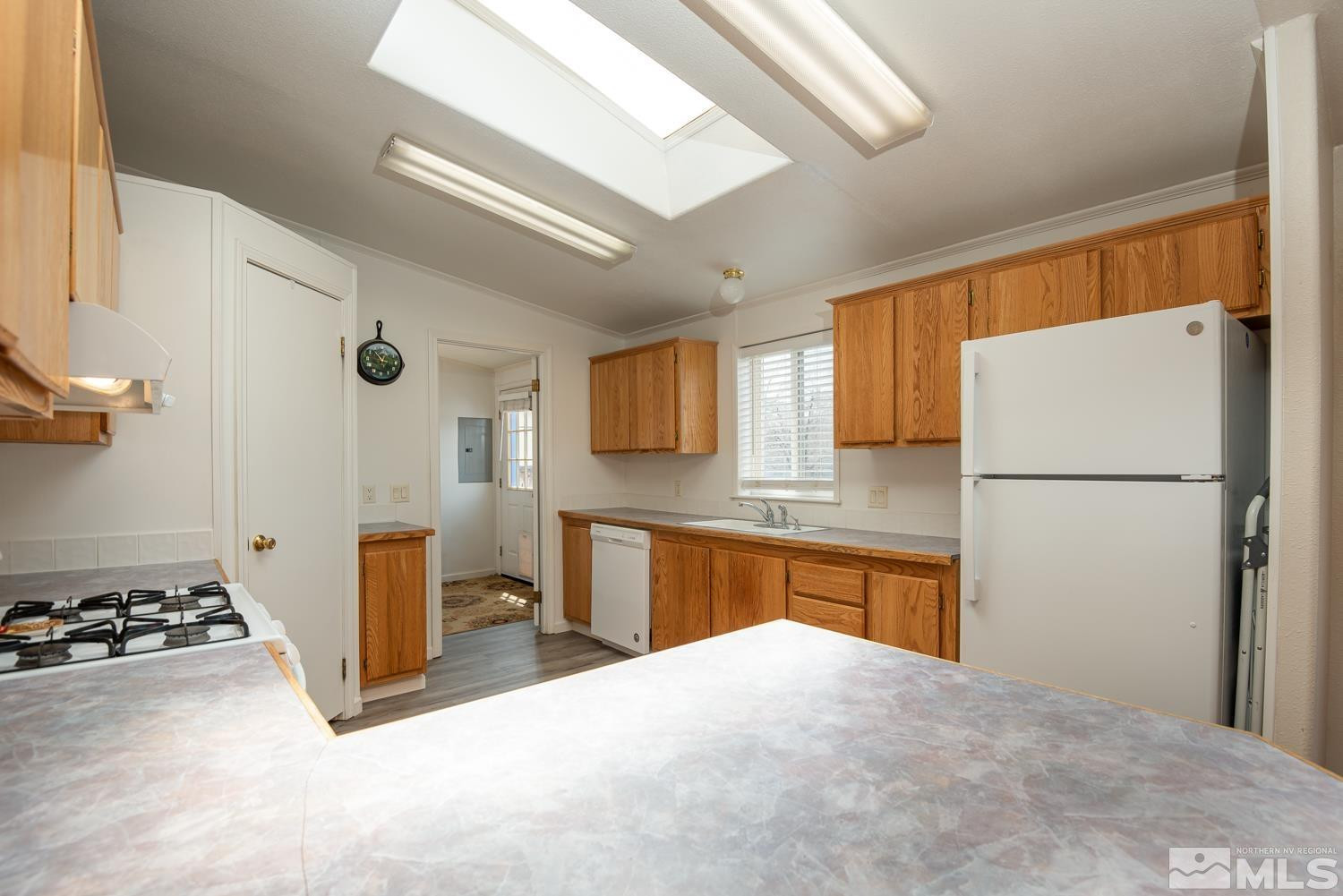 15485 Toll Road Reno, NV 89521 - Photo 6 of 29 a kitchen with a refrigerator and a stove top oven