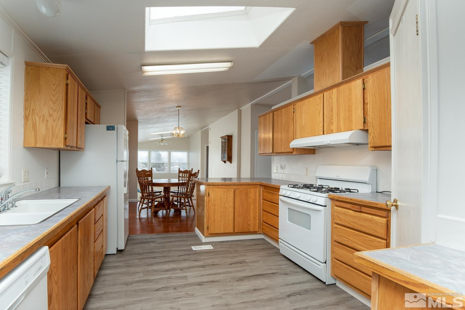 15485 Toll Road Reno, NV 89521 - Photo 8 of 29 a kitchen with stainless steel appliances granite countertop a stove a sink and a refrigerator
