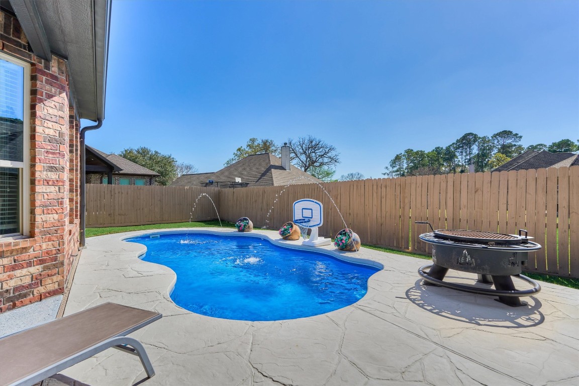 226 Hampton Glen Road Montgomery, TX 77356 - Photo 35 of 48 Charming backyard with an in-ground pool, perfect for relaxation and entertainment.