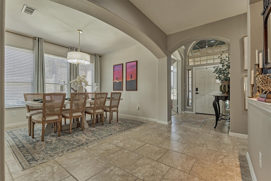 226 Hampton Glen Road Montgomery, TX 77356 - Photo 6 of 48 Bright and inviting entryway leading to a spacious formal dining area. Features tiled floors, archways, and large windows that allow natural light. Perfect for entertaining.