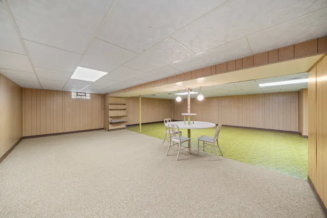 a view of a room with a table and chairs