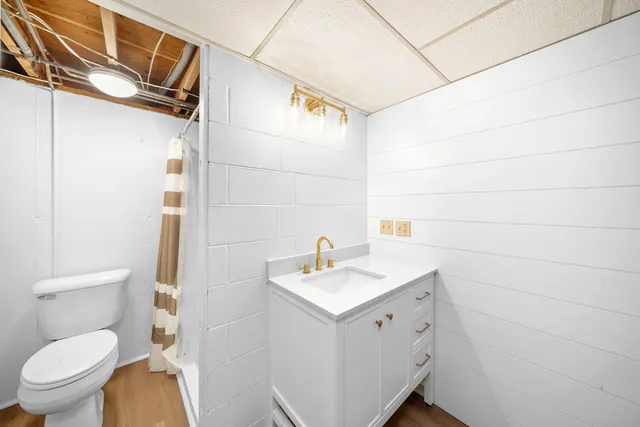 a bathroom with a sink toilet and shower