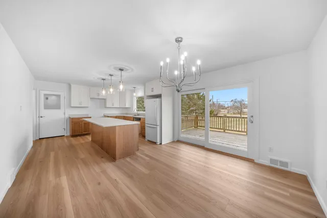 a large kitchen with cabinets wooden floor and stainless steel appliances