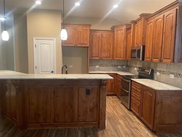 a kitchen with a sink cabinets and window