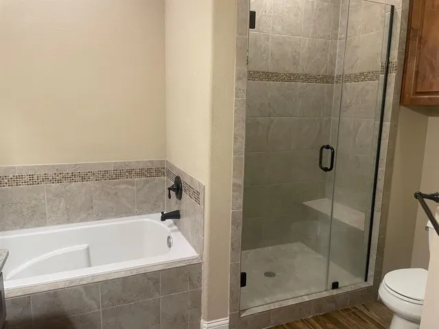 a bathroom with a bathtub and a shower