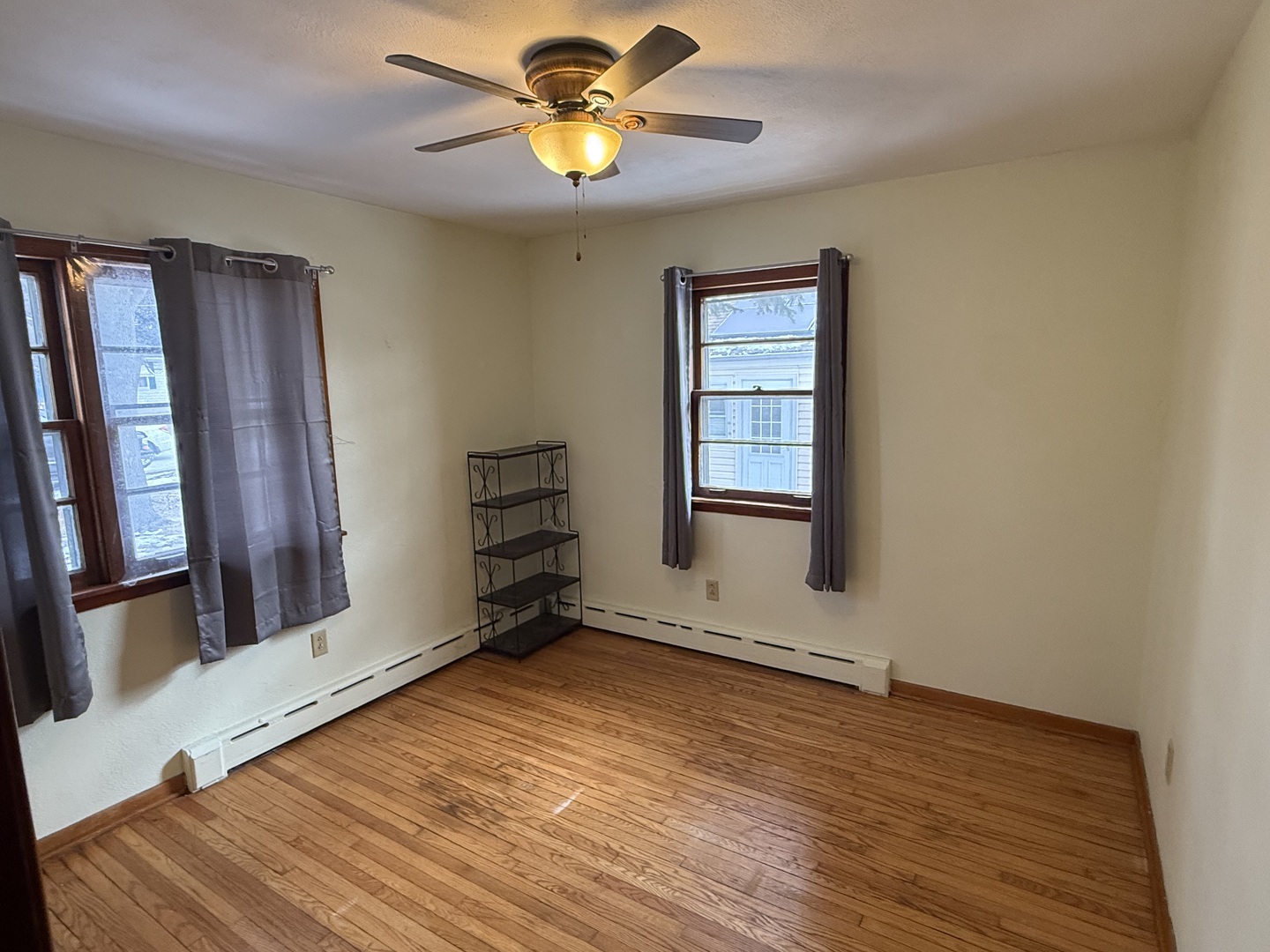 1505 East Street Lockport, IL 60441 - Photo 3 of 6 a view of an empty room with a window and wooden floor