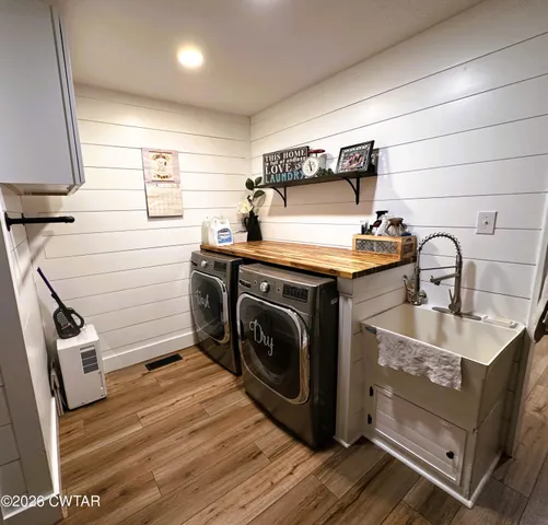 a utility room with sink dryer and washer
