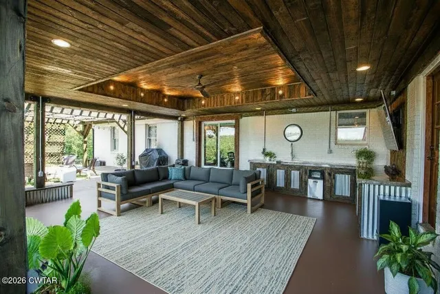 a living room with furniture a fireplace and a table