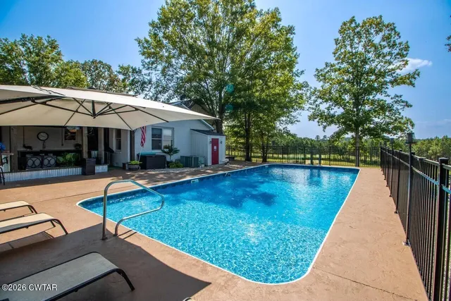 a view of swimming pool with chairs