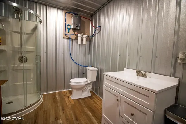 a bathroom with a sink a toilet and shower