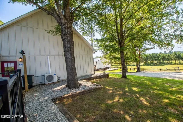 a backyard of a house with table and chairs