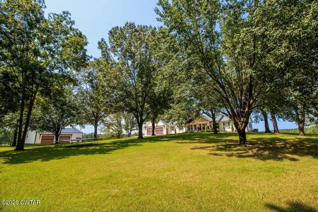 a view of swimming pool with outdoor seating and trees