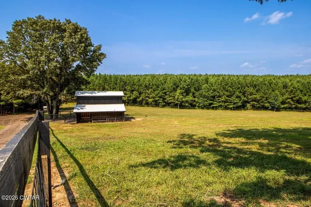 a view of a swimming pool with an outdoor seating and yard