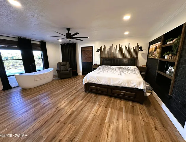 a bed sitting in a room next to a window