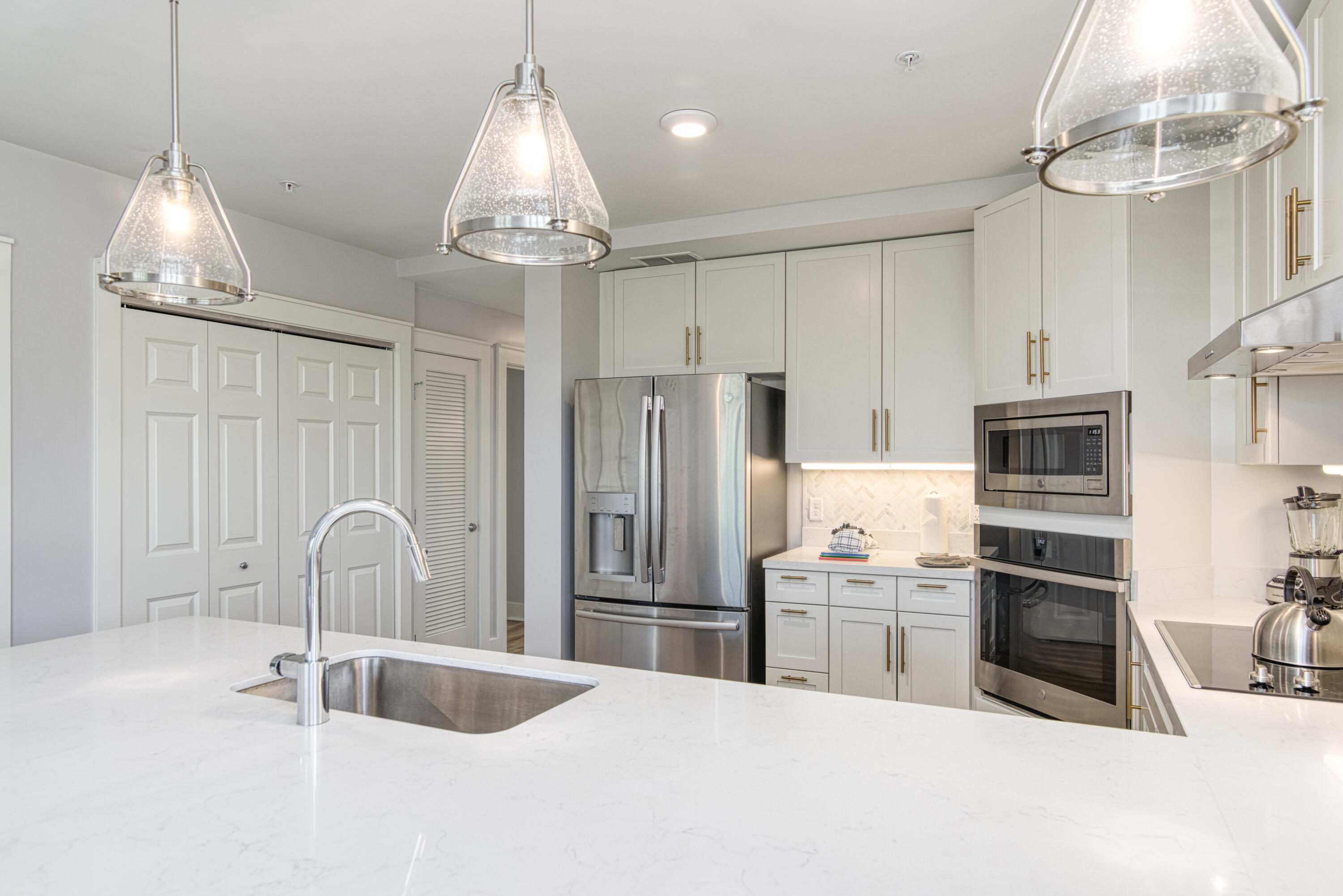 9000 Heron Walk Drive, Unit 3104 Miramar Beach, FL 32550 - Photo 4 of 45 a kitchen with stainless steel appliances granite countertop a sink refrigerator and cabinets