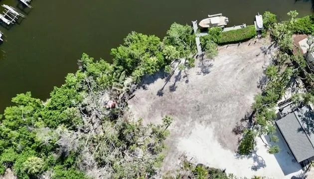 an aerial view of a house with outdoor space and lake view