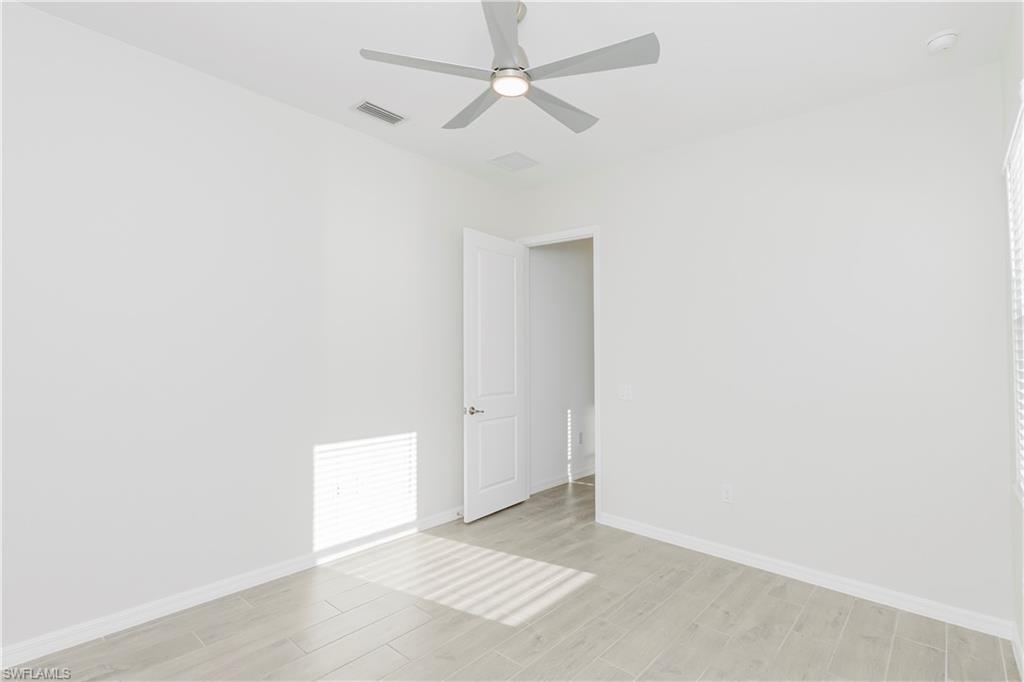 5423 Ternberry Road Ave Maria, FL 34142 - Photo 10 of 46 an empty room with a ceiling fan and a window