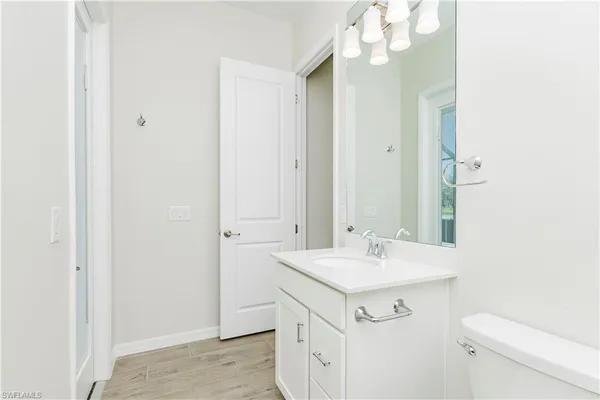 a bathroom with a sink a mirror and a toilet