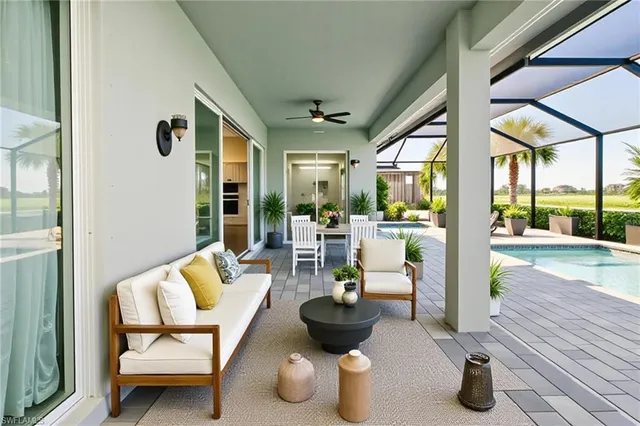 a living room with patio furniture and a potted plant