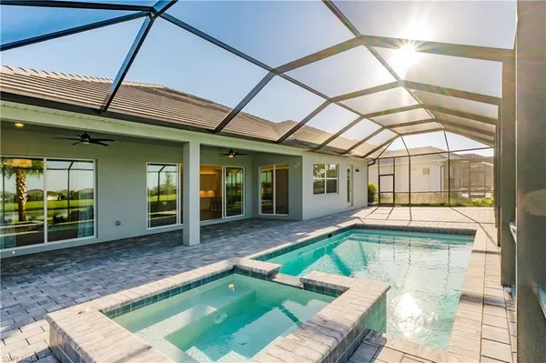 a view of a house with pool fire pit and outdoor seating