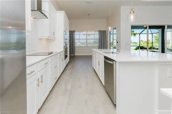 a large kitchen with a stove and a sink