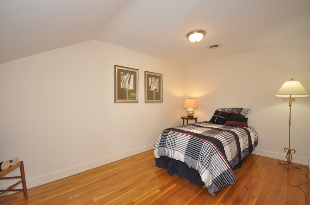 16 Childs Road Lexington, MA 02421 - Photo 16 of 29 a bedroom with a bed and a lamp