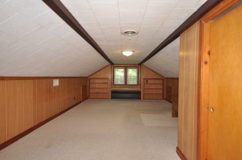 16 Childs Road Lexington, MA 02421 - Photo 19 of 29 a view of an empty room with a fireplace and a window