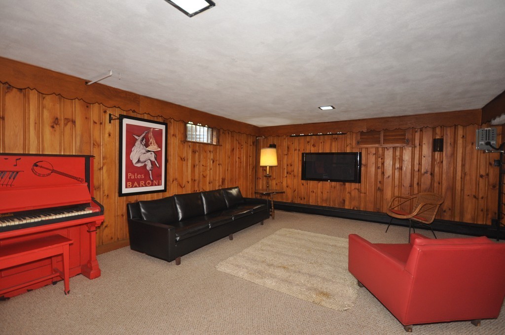 16 Childs Road Lexington, MA 02421 - Photo 20 of 29 a living room with furniture a flat screen tv and dresser