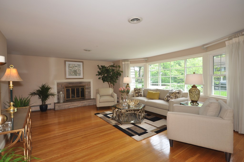16 Childs Road Lexington, MA 02421 - Photo 5 of 29 a living room with furniture floor to ceiling window and a fireplace