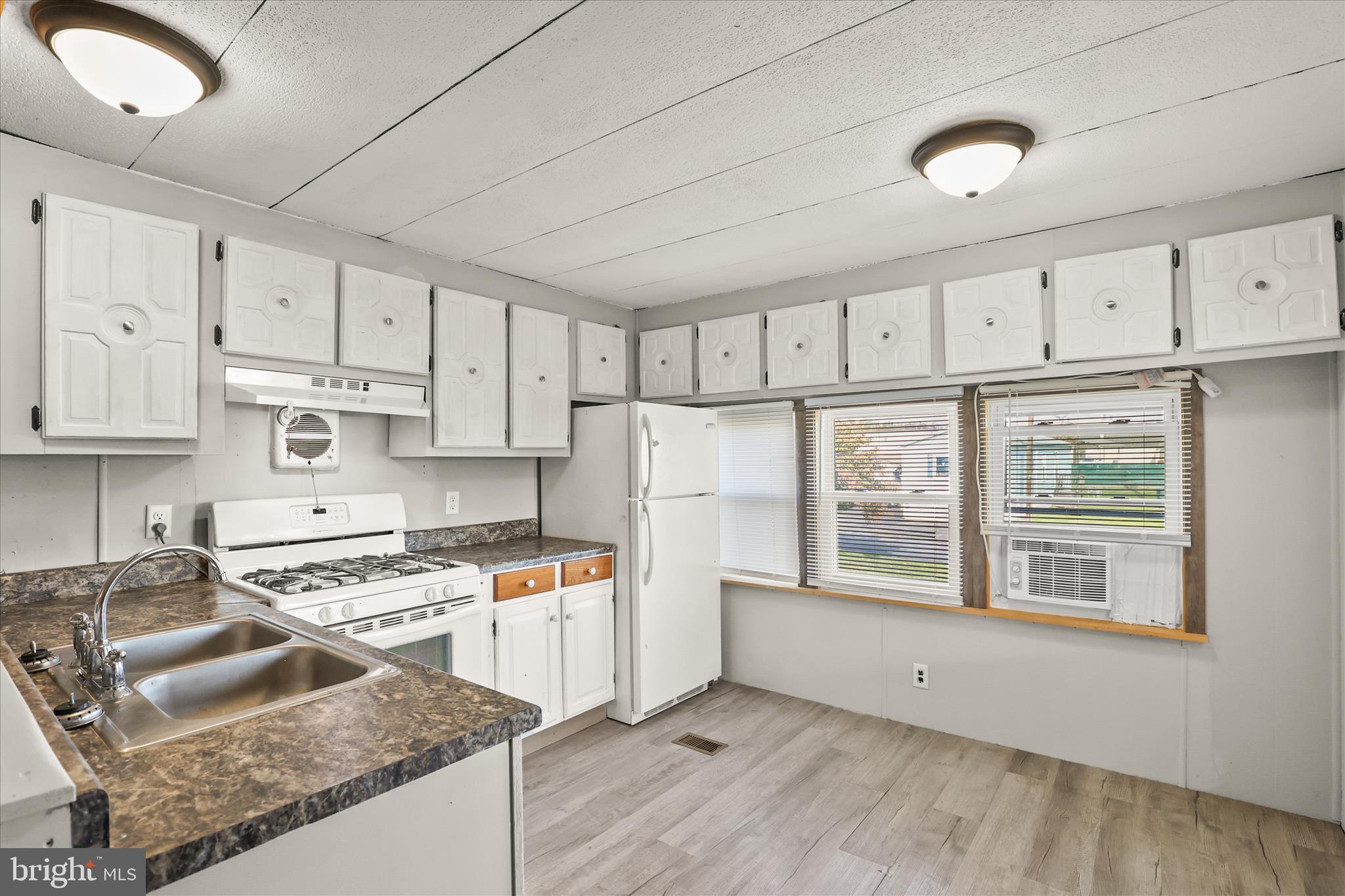 3720 Davidsburg Road, Unit A12 Dover, PA 17315 - Photo 17 of 32 a kitchen with stainless steel appliances granite countertop a stove a sink and white cabinets