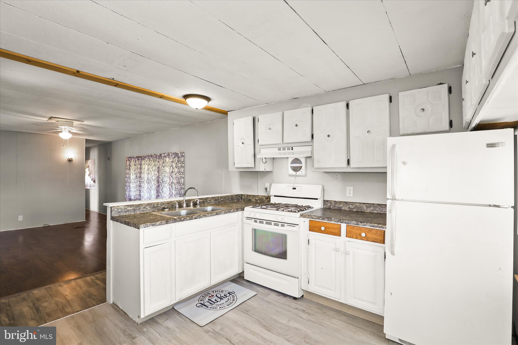 3720 Davidsburg Road, Unit A12 Dover, PA 17315 - Photo 18 of 32 a kitchen with a stove a refrigerator and white cabinets