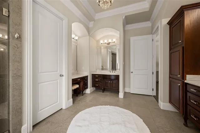 a bathroom with a granite countertop sink a mirror and a bathtub