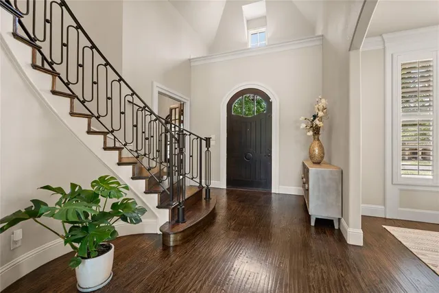 a living room with furniture a fireplace and a large window