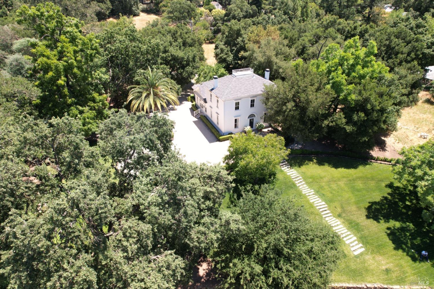 an aerial view of a house with a yard and garden