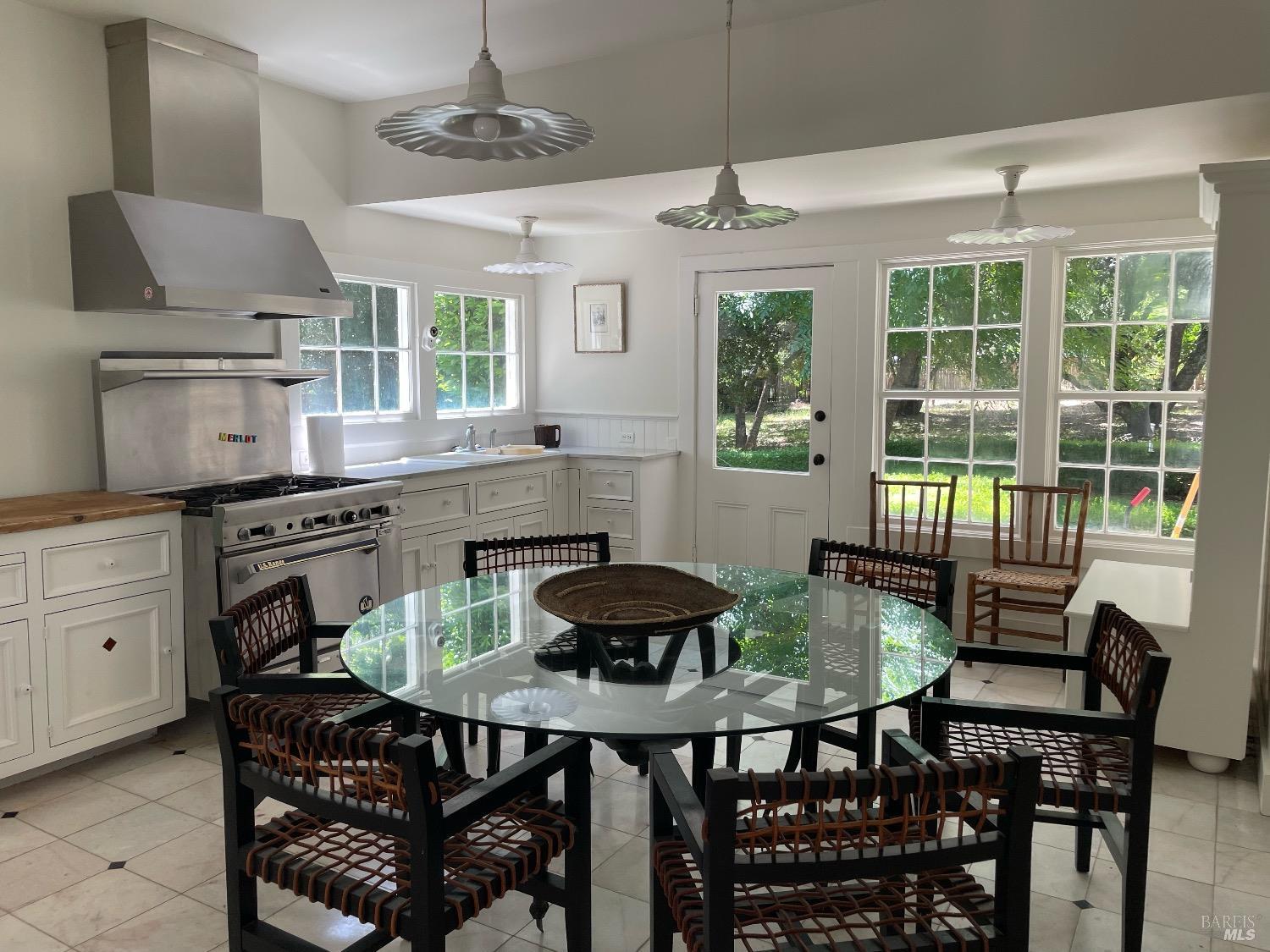751 Crystal Springs Road St. Helena, CA 94574 - Photo 11 of 25 a kitchen with stainless steel appliances granite countertop a dining table and chairs
