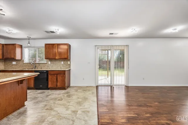 a large kitchen with stainless steel appliances granite countertop a granite counter tops and a wooden floors