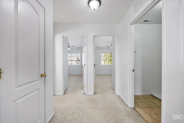 an empty room with closet and windows
