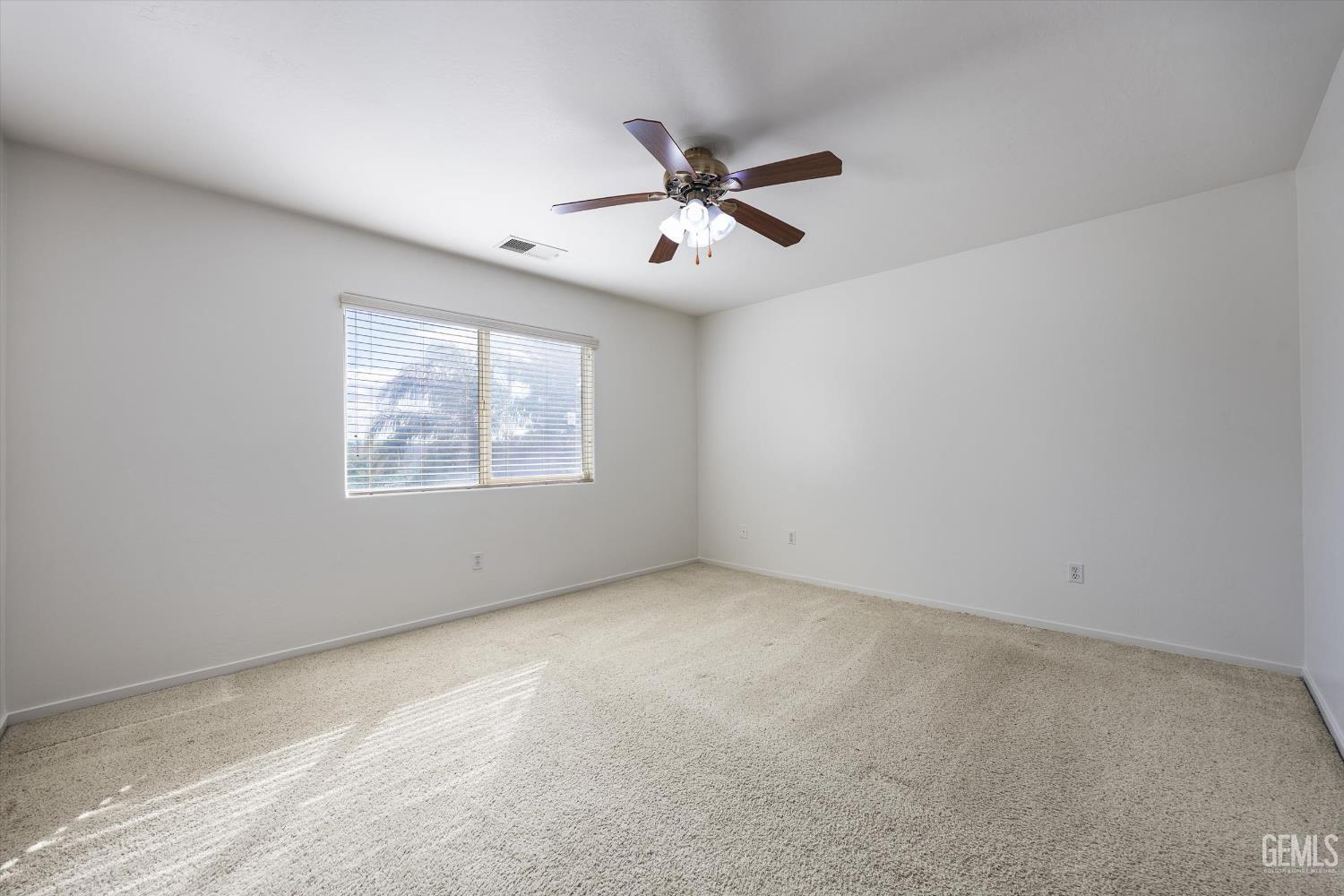Undisclosed Address Bakersfield, CA 93312 - Photo 30 of 42 an empty room with a window and a fan