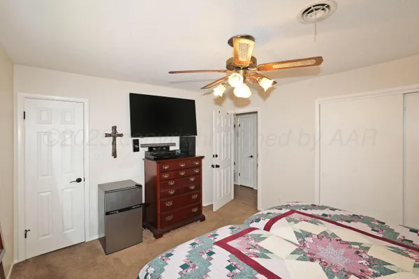 a bedroom with a bed and flat screen tv