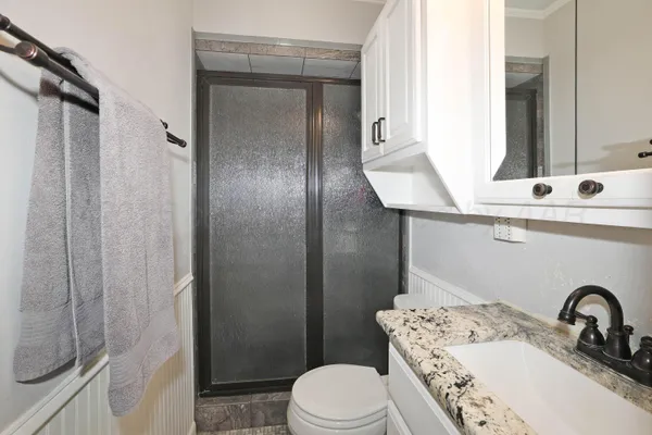 a bathroom with a sink toilet and shower