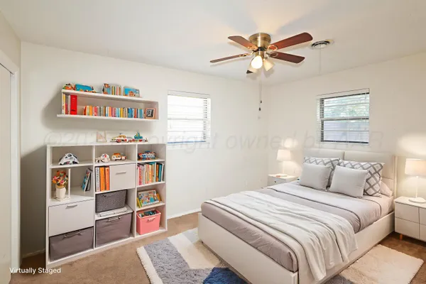 a bedroom with a bed and a book shelf