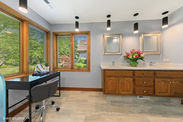 16 Tartan Ridge Road Burr Ridge, IL 60527 - Photo 12 of 30 a spacious bathroom with a double vanity sink large mirror and a large window