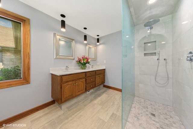 16 Tartan Ridge Road Burr Ridge, IL 60527 - Photo 13 of 30 a bathroom with a shower sink and mirror