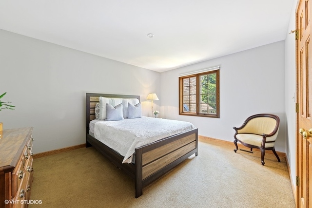 16 Tartan Ridge Road Burr Ridge, IL 60527 - Photo 16 of 30 a bedroom with a bed chair and a window