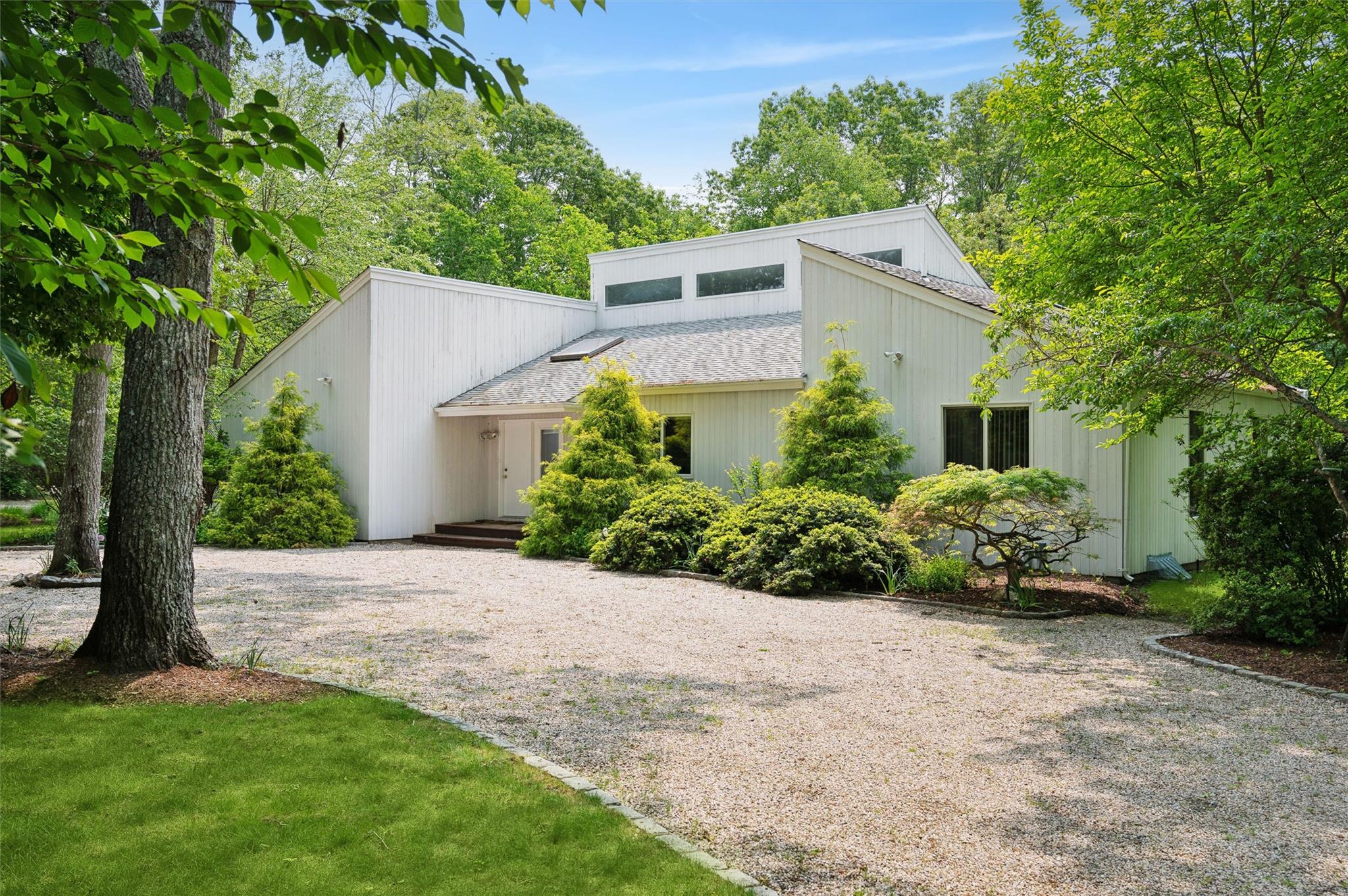 8 Midhampton Court Quogue, NY 11959 - Photo 1 of 1 a front view of a house with a yard