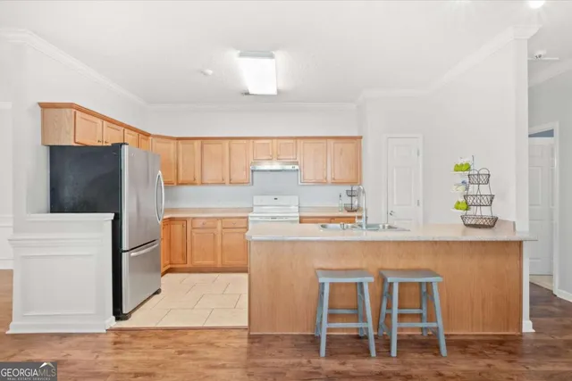 a kitchen with stainless steel appliances a refrigerator and a stove top oven