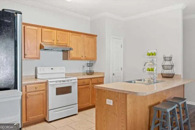 a kitchen that has a sink and a stove in it