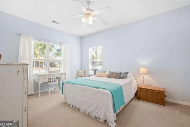 a bedroom with a bed and a table with chair