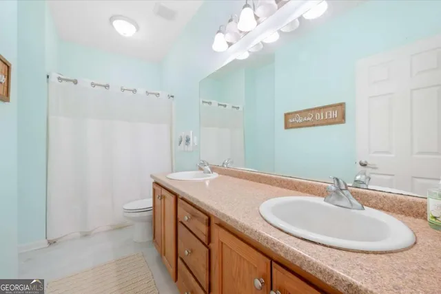 a bathroom with a sink a vanity and a mirror