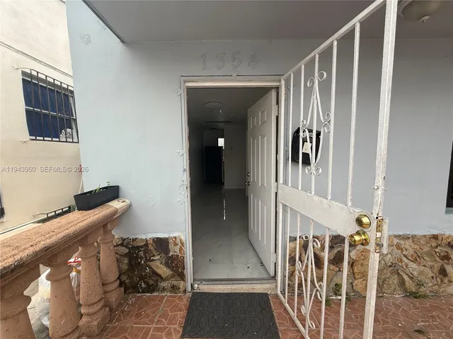 a view of hallway with wooden floor